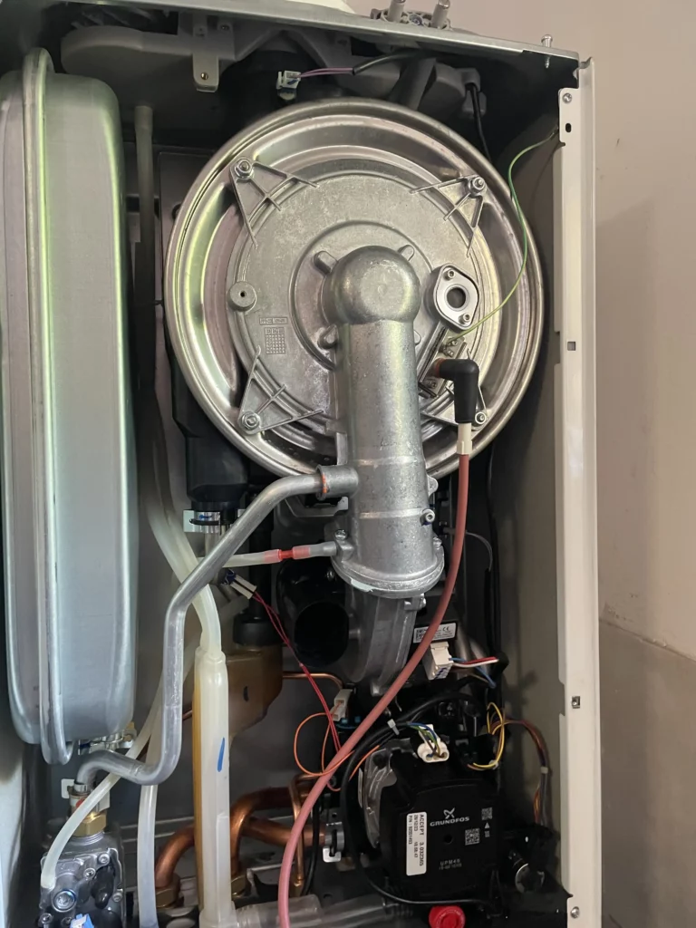 Plynoměr zapojený na plynové potrubí ve zdi